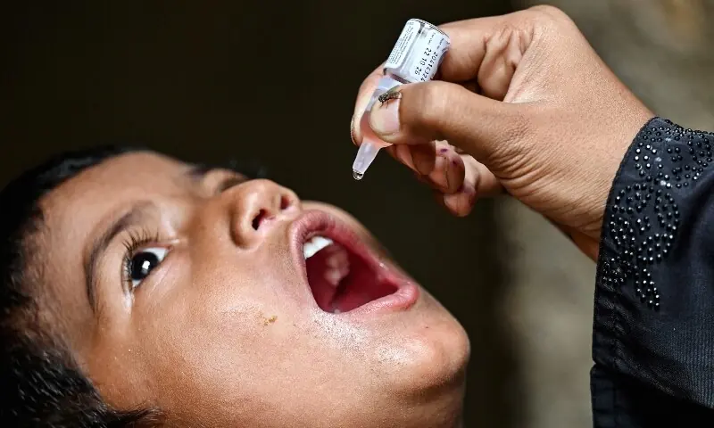 A health worker administers polio drops to a child for vaccination on the first day of a nationwide week-long poliovirus eradication campaign in Karachi on September 1. &mdash; AFP