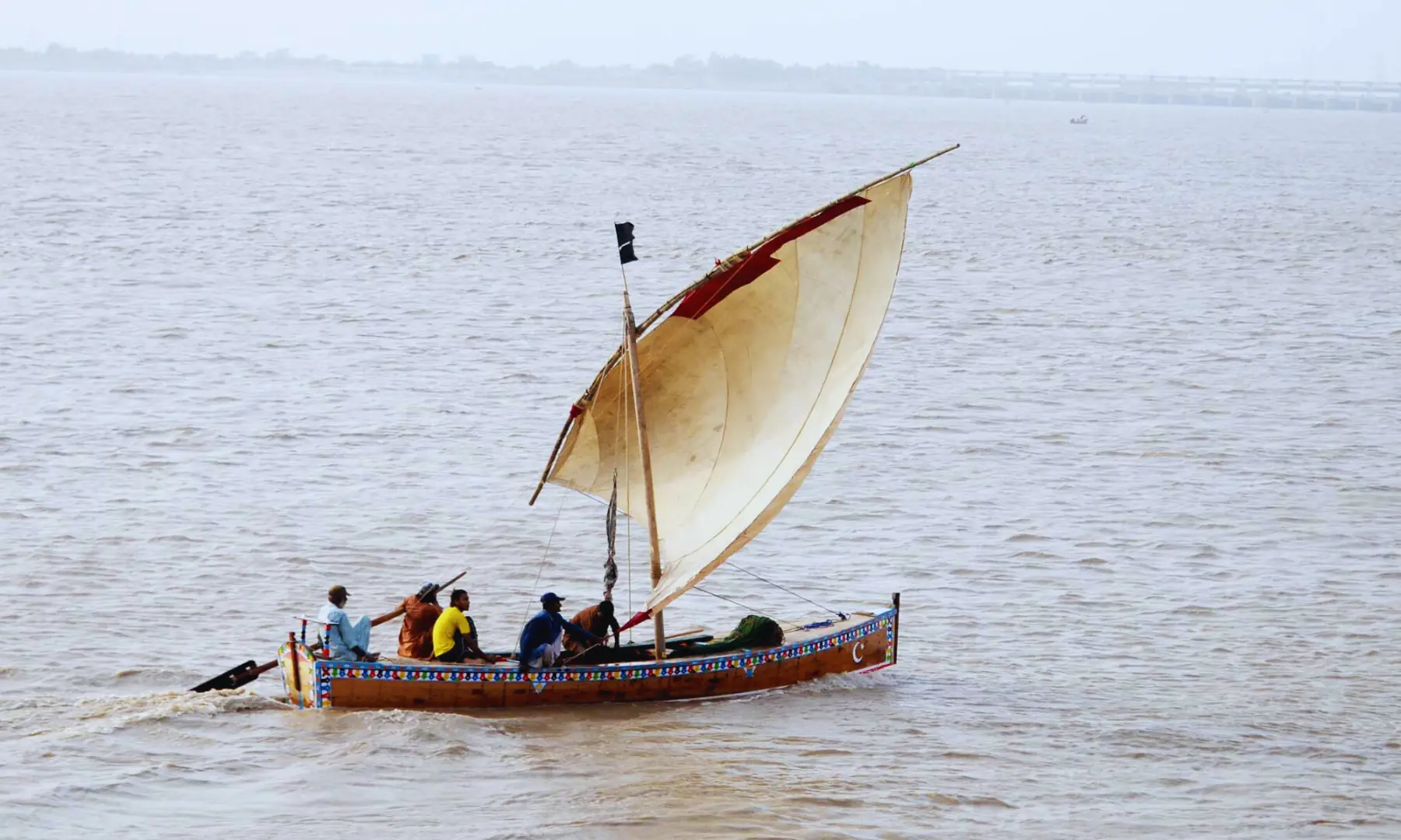 Fishermen on board their wooden boats busy in fishing in Indus river downstream Kotri barrage.
