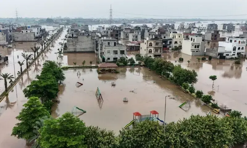This aerial view shows partially submerged residential buildings following the overflowing of the Ravi River in Lahore on August 30. &mdash; AFP
