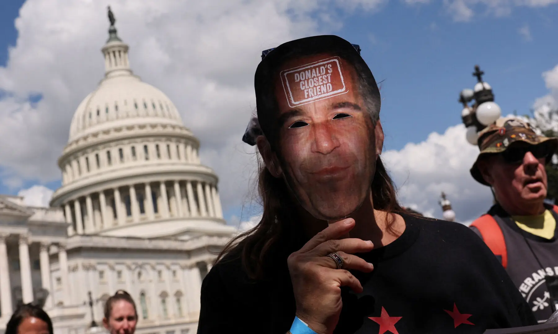 An anti-Trump protester holding a mask depicting Jeffrey Epstein marches at the US Capitol in Washington, DC, US on September 2, 2025. &mdash; Reuters/Jonathan Ernst