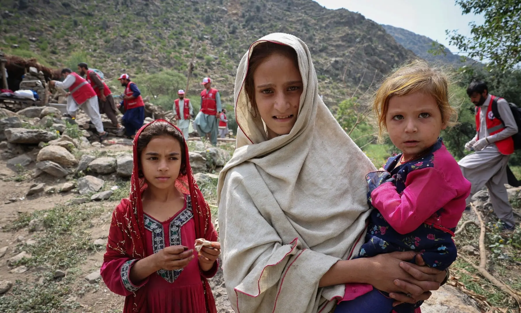 Afghan girls stand near their damaged house following a deadly magnitude-6 earthquake that struck Afghanistan on Sunday in Nurgal district, Kunar province, Afghanistan on September 3. — Reuters