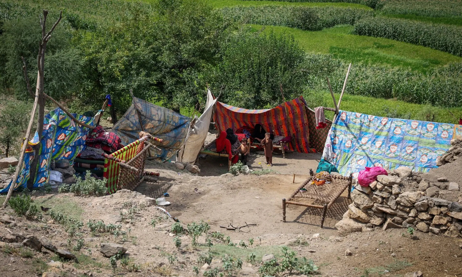 An Afghan family sits inside a makeshift shelter following a deadly magnitude-6 earthquake that struck Afghanistan on Sunday, in Nurgal district, Kunar province, Afghanistan on September 3. — Reuters