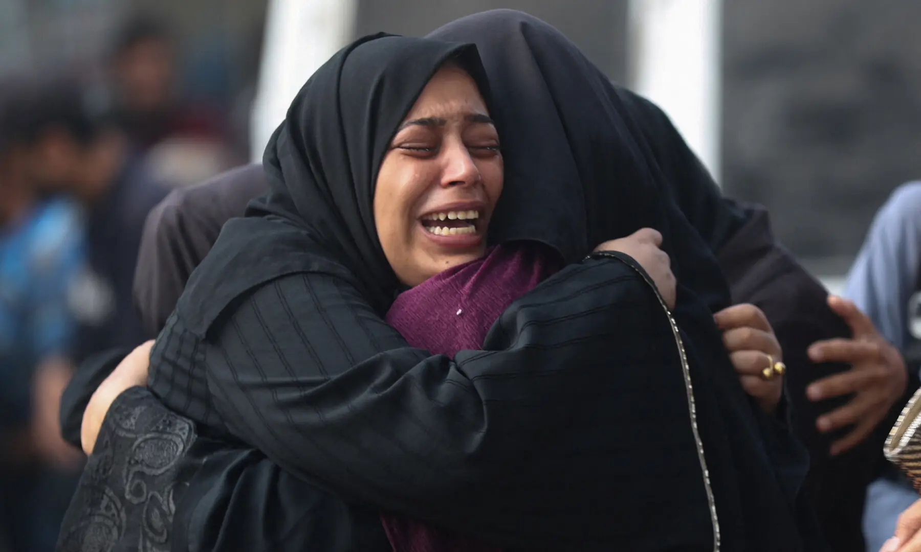 Mourners embrace during the funeral of Palestinians killed in overnight Israeli strikes, according to medics, at Al-Shifa Hospital in Gaza City on Sept 5, 2025. — Reuters/Mahmoud Issa