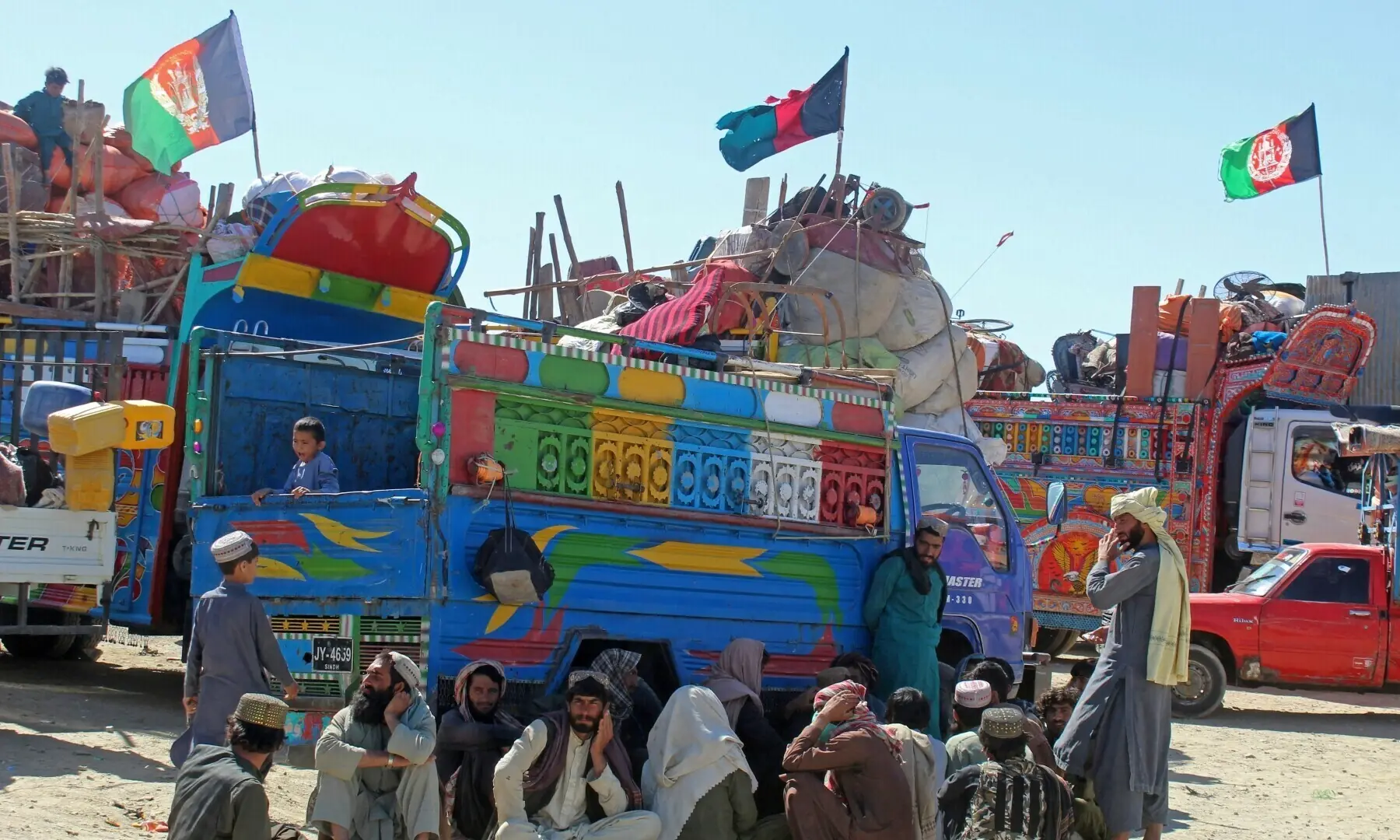 Afghan refugees due for deportation to Afghanistan wait with their belongings outside a holding centre near the Pakistan-Afghanistan border in Chaman on April 22, 2025. &mdash; AFP/File