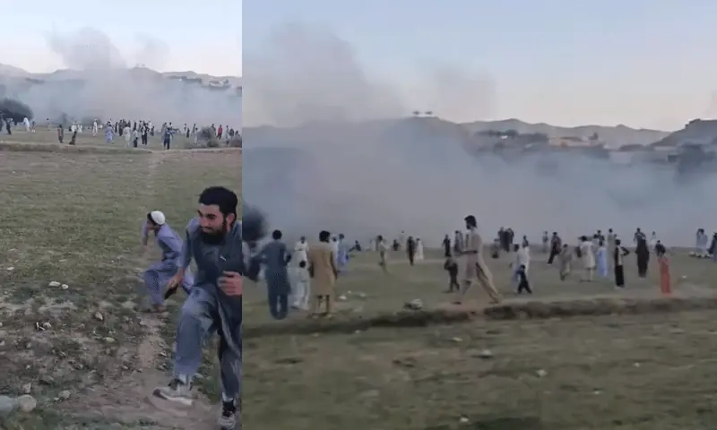 People run and a cloud of smoke is visible after an explosion at a cricket ground in KP&rsquo;s Bajaur on September 6. &mdash; DawnNewsTV