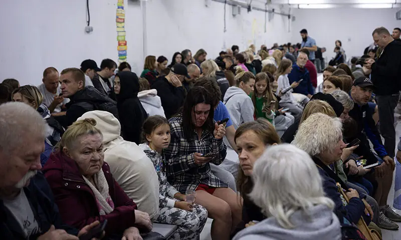 People sit in a shelter during Russian drone and missile strikes in Kyiv, Ukraine on September 7AFP)