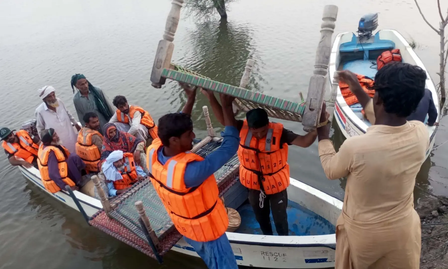 A FLOOD-AFFECTED family evacuated from a village is being brought to safety near Multan on Sunday, while five people drowned in Jalalpur Pirwala after a boat capsized in the Chenab during the evacuation. Rescue officials say more than 9,000 people have been rescued in the Multan district alone.&mdash;PPI