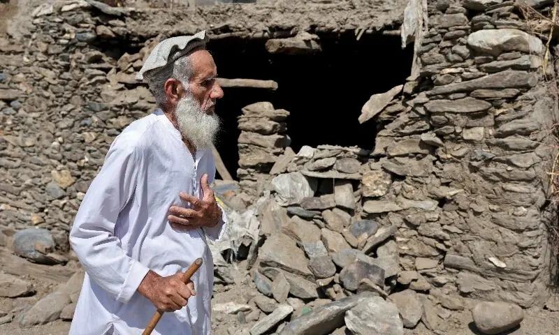 A 67-year-old farmer, walks past a damaged house following a deadly earthquake in Afghanistan&rsquo;s Kunar and Nangarhar provinces, September 4. &mdash; Reuters