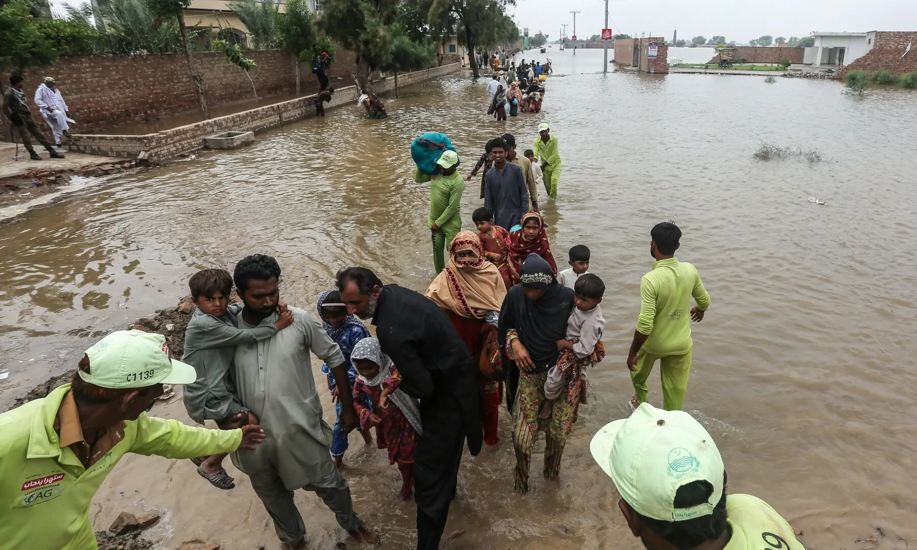 Flood-affected residents wade through floodwaters in Jalalpur Pirwala of the Multan district in Punjab on September 8, 2025. &mdash; AFP