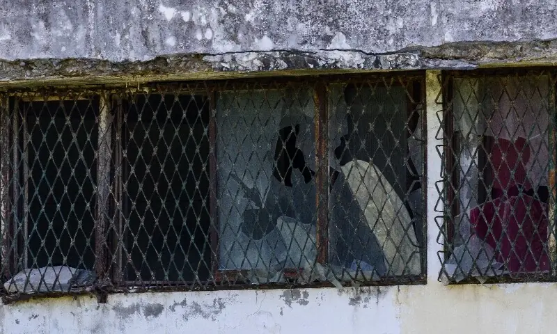 Vandalised windows and a security grill are seen outside a building slated for demolition that was once a clinic in Dongducheon for sex workers hired to serve US soldiers. &mdash; AFP