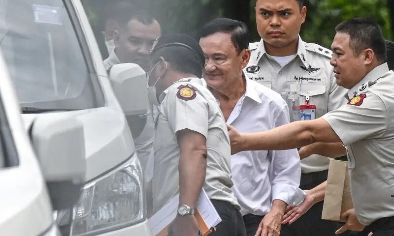 Thailand’s former Prime Minister Thaksin Shinawatra (C) is escorted into a police van outside the Supreme Court in Bangkok on September 9. — AFP Thailand’s former Prime Minister Thaksin Shinawatra (C) is escorted into a police van outside the Supreme Court in Bangkok on September 9. — AFP
