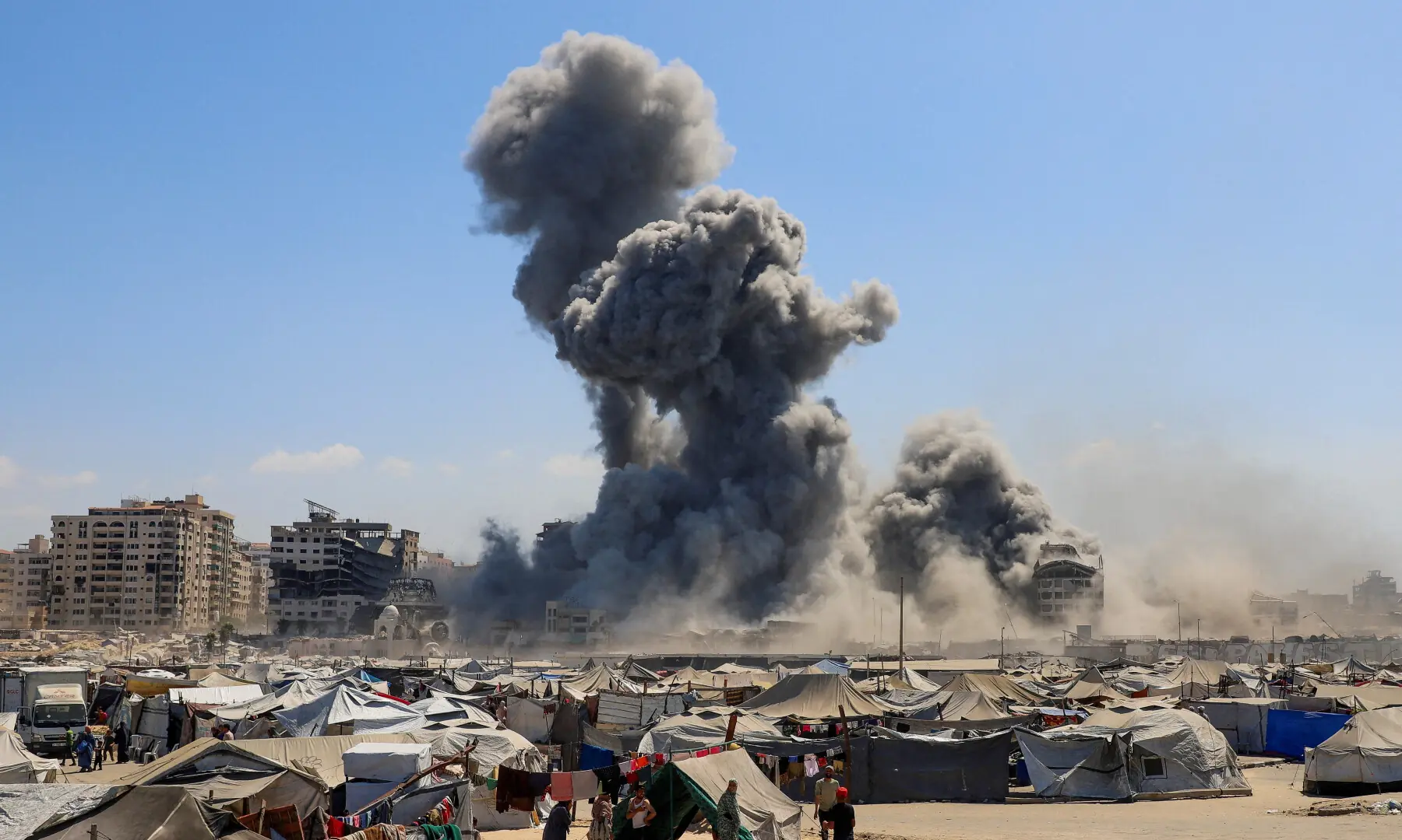 Smoke rises as an evacuated residential building, which was housing displaced Palestinians, collapses after it was hit by an Israeli air strike, near a tent camp sheltering displaced people, in Gaza City on Sept 10, 2025. — Reuters/Ebrahim Hajjaj