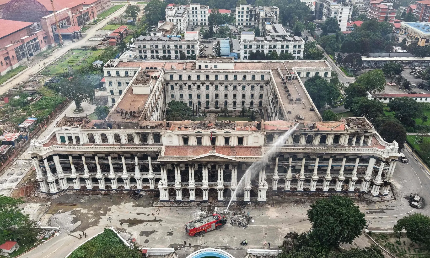 An aerial view shows firefighters dousing the torched Singha Durbar, the main administrative building for the Nepal government, a day after it was set ablaze by protesters in Kathmandu on September 10, 2025. — AFP