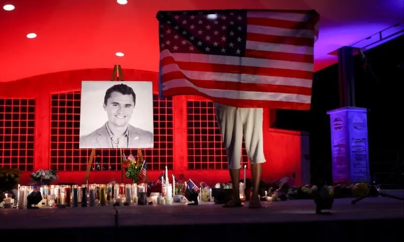A person holds a US flag during a vigil at Orem City Centre Park, after U.S. right-wing activist and commentator, Charlie Kirk, an ally of U.S. President Donald Trump, was fatally shot during an event at Utah Valley University, in Orem, Utah, US, September 11, 2025. &mdash; Reuters