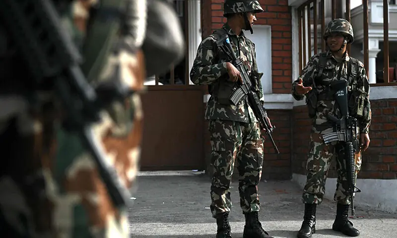 Army personnel stand guard along a street during a curfew imposed to restore law and order in Kathmandu, Nepal on September 12. &mdash; AFP