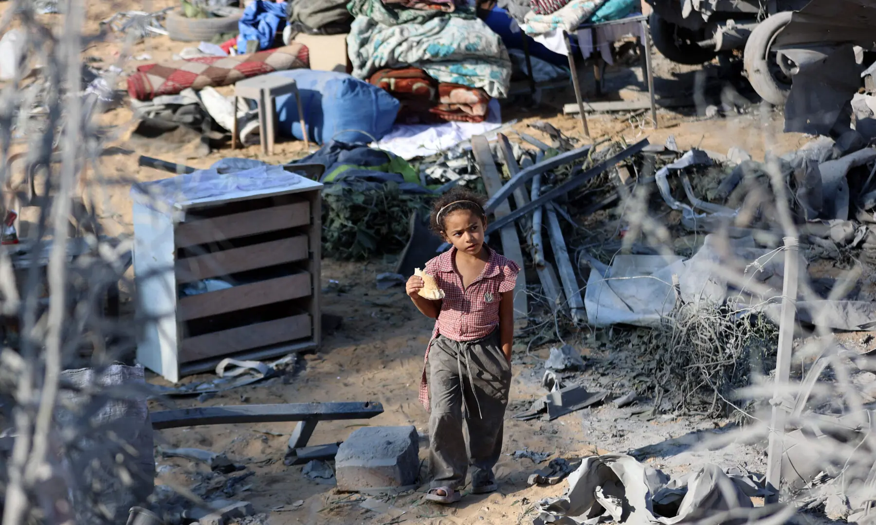  A displaced Palestinian child walks amid devastated tents, following an overnight Israeli strike that levelled a building and damaged the surrounding temporary shelters, in the Rimal neighbourhood of Gaza City on Sept 13, 2025. &mdash; AFP 