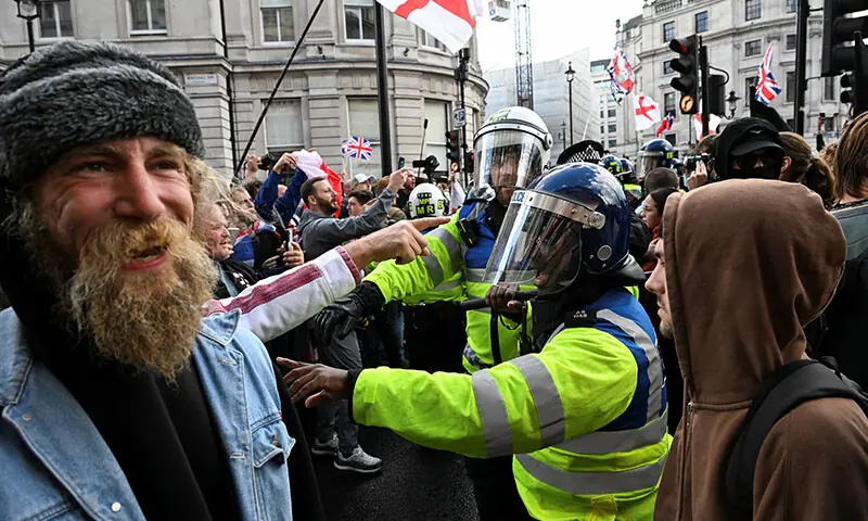 Police officers confront the supporters of British anti-immigration activist Tommy Robinson, during a demonstration of the Stand Up to Racism campaign group, in London, Britain on September 13. — Reuters