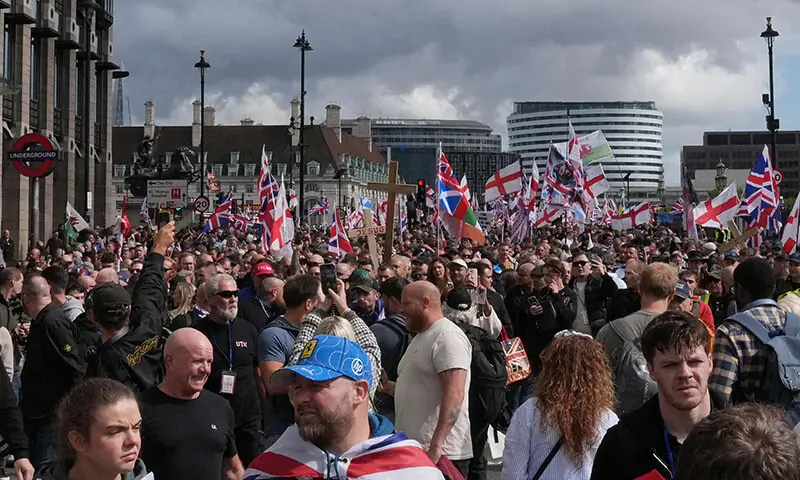 Supporters of British far-right activist Tommy Robinson, whose real name is Stephen Yaxley-Lennon, wave Union Jack, St George’s cross and Welsh flags as they walk through central London during a ‘Free speech’ march, on September 13. — AFP