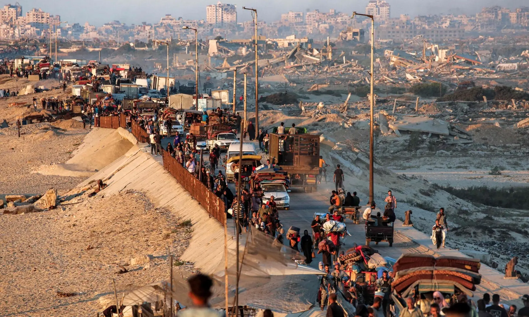 Displaced Palestinians evacuating southbound from Gaza City travel on foot and by vehicle along the coastal road in Nuseirat in the central Gaza Strip on Sept 13, 2025. — AFP