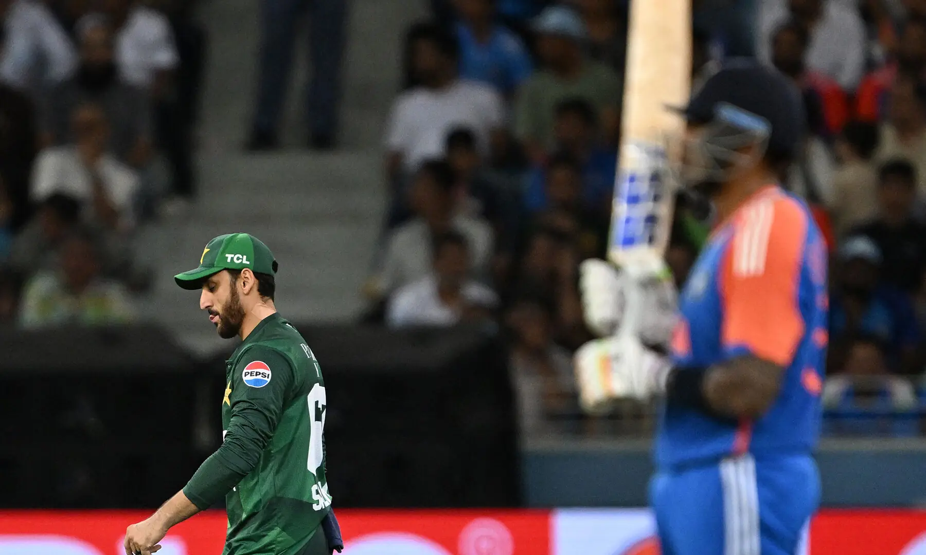 Pakistan’s captain Salman Agha (L) and India’s captain Suryakumar Yadav look on during the Asia Cup 2025 Twenty20 international cricket match between India and Pakistan at the Dubai International Stadium in Dubai on September 14, 2025. (Photo by SAJJAD HUSSAIN / AFP)