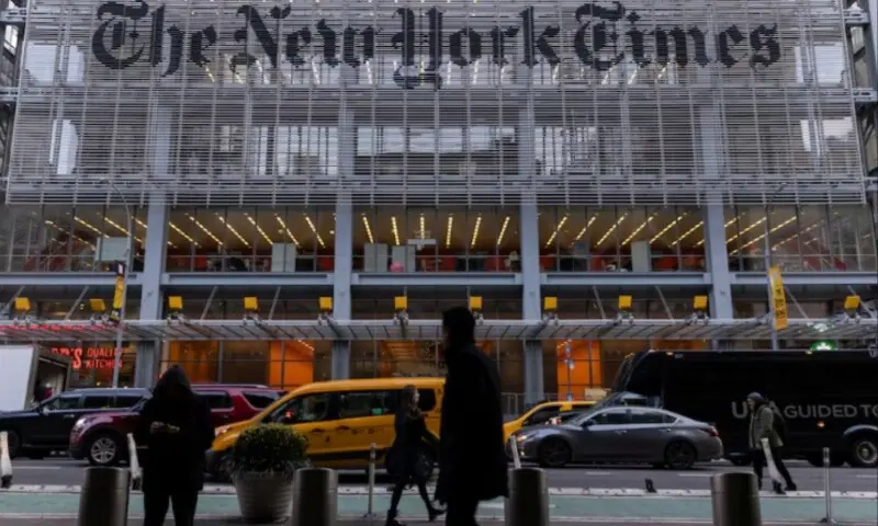 Pedestrians walk by the New York Times building in Manhattan, New York, US on December 8, 2022. &mdash; Reuters/Jeenah Moon/File Photo
