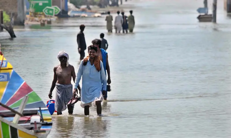  People wade through floodwater after the Sutlej River overflowed, inundating low-lying areas of Jalalpur Pirwala tehsil in Punjab&rsquo;s Multan district, on Sept 15, 2025. &mdash; APP 