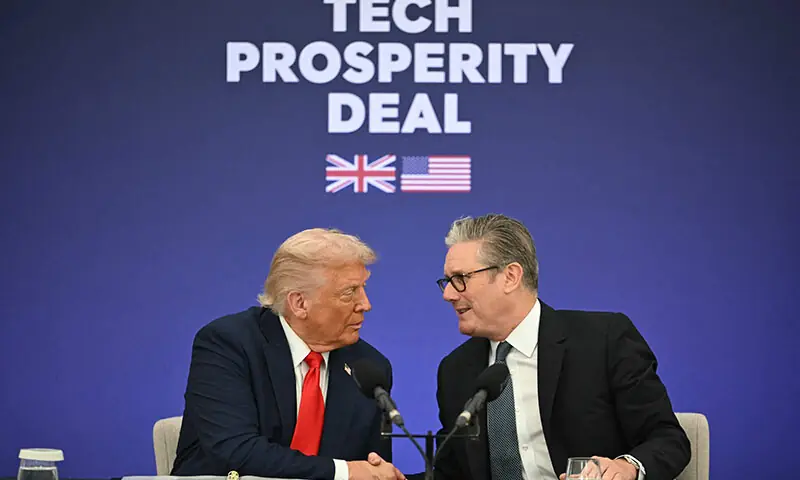 Britain’s Prime Minister Keir Starmer (R) and US President Donald Trump (L) shake hands as the pair sign a tech deal at Chequers, in Aylesbury, central England, on September 18. — AFP