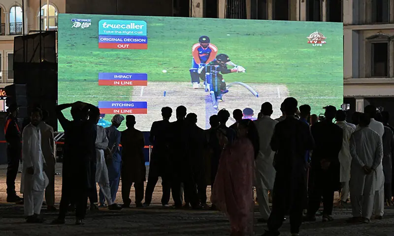 Cricket fans watch a live broadcast of the Asia Cup 2025 T20 International cricket match between Pakistan and India on a big screen in Islamabad on September 14. &mdash; AFP