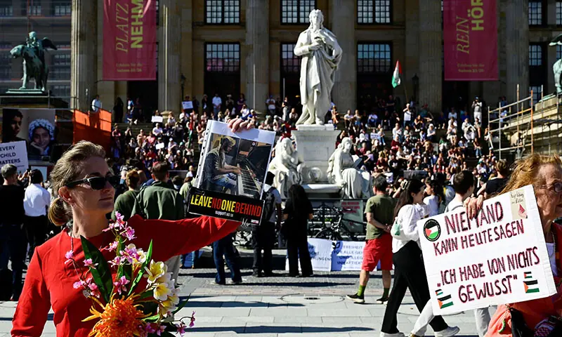 Politician Karoline Preisler (L) poses with a placard on the sidelines of a classical concert in support of the children in Gaza, at the Gendarmenmarkt square outside the Konzerthaus concert hall in Berlin, Germany on September 20. — AFP