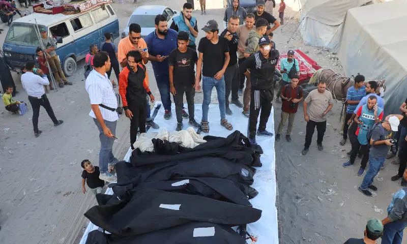 Mourners gather for a funeral around body bags containing the remains of the Dugmosh family, who were killed in an Israeli strike on a house on Saturday amid their military operation, according to medics, at Al-Shifa Hospital in Gaza City on Sept 21, 2025. — Reuters
