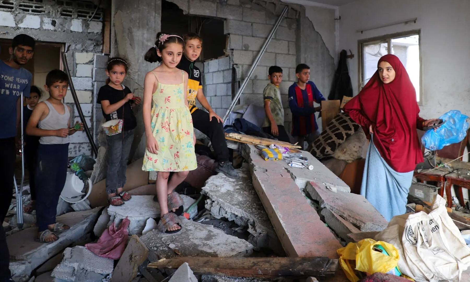  Palestinians kids gather as they inspect the damage inside a house belonging to Al-Hadad family after it was hit in an overnight Israeli strike, amid an Israeli military operation, in Gaza City on September 21, 2025. &mdash; Reuters/Ebrahim Hajjaj 