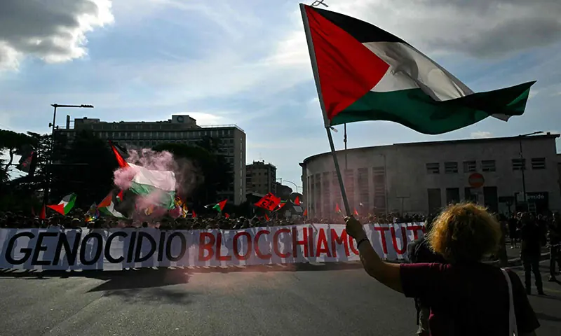 People march behind a banner reading &lsquo;Against Genocide Let&rsquo;s Block Everything&rsquo; during a nationwide strike in solidarity with Palestinians in Gaza and calling for a halt to arms shipments to Israel, in Rome, Italy on September 22. &mdash; AFP