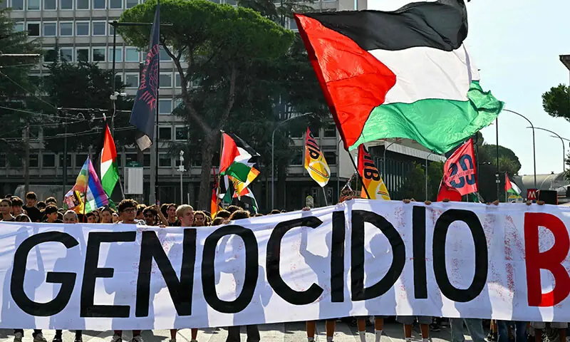 People march behind a banner reading &lsquo;Against Genocide Let&rsquo;s Block Everything&rsquo; during a nationwide strike in solidarity with Palestinians in Gaza and calling for a halt to arms shipments to Israel, in Rome on September 22. &mdash; AFP