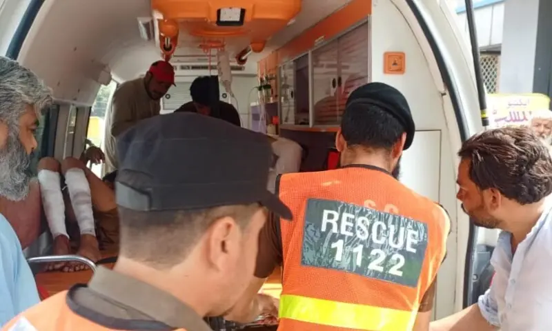 Rescue 1122 personnel providing first aid to the injured after a grenade explosion in Mardan on Sept 23. — Photo via Zahid Imdad