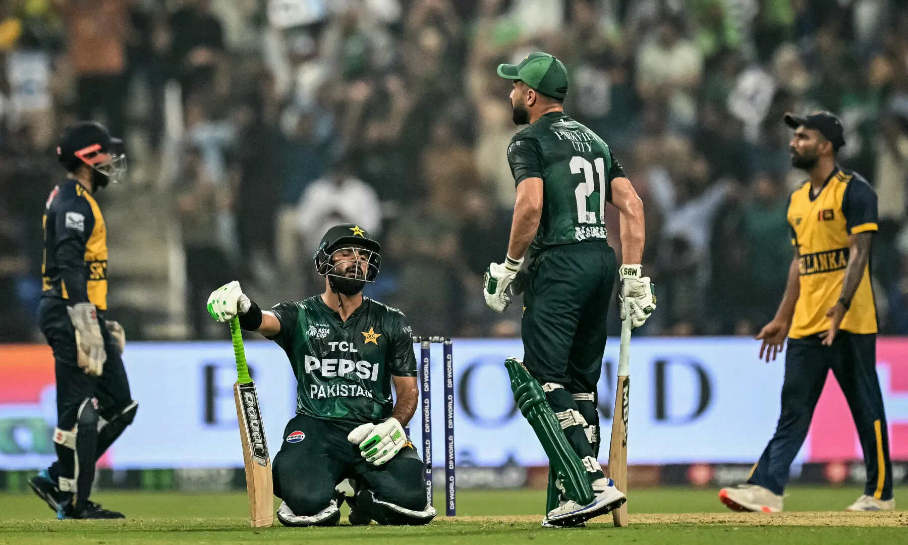 Hussain Talat (2L) sits on ground as he speaks with his teammate Mohammad Nawaz (2R) during the Asia Cup 2025 Super Four Twenty20 international cricket match between Pakistan and Sri Lanka at the Sheikh Zayed Cricket Stadium in Abu Dhabi on September 23. — AFP