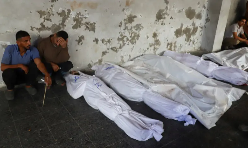 Mourners react near the bodies of Palestinians, who, according to medics, were killed in a deadly overnight Israeli strike on a building where displaced people were taking shelter, amid an Israeli military operation, at Al-Ahli Arab Hospital in Gaza City, on September 24. &mdash; Reuters