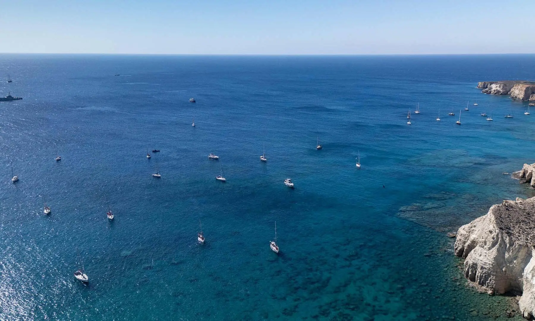 A group of ships of the Global Sumud Flotilla to Gaza are shown moored at the small island of Koufonisi, south of the island of Crete on September 26, 2025. After a reported attack by drones early on September 25, 2025 morning, Athens has said it will guarantee safe sailing in its waters.  AFP)