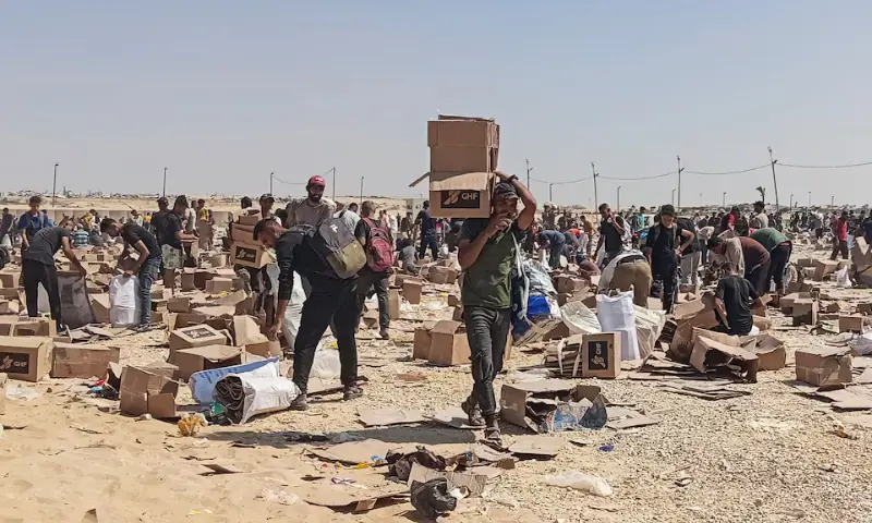 Palestinians gather to collect what remains of relief supplies from the distribution center of the US-backed Gaza Humanitarian Foundation, in Rafah, in the southern Gaza Strip, on June 5. &mdash; Reuters/File