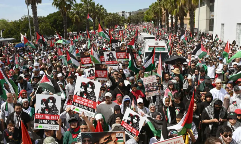 Protesters hold placards and Palestinian flags as they march through the city centre during civil society and faith-based organisations&rsquo; mass rally for Gaza, in Cape Town on September 27, 2025. &mdash; AFP