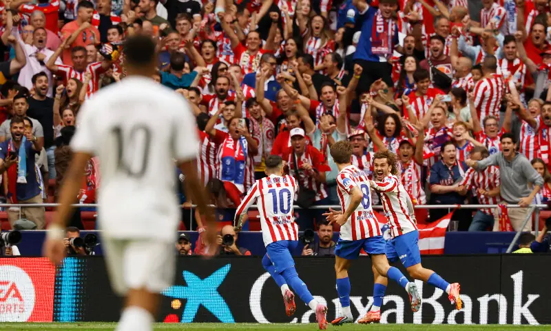 Atletico Madrid&rsquo;s Antoine Griezmann celebrates scoring their fifth goal with Pablo Barrios and Alex Baena as Real Madrid&rsquo;s Kylian Mbappe looks on in Madrid, Spain on Sept 27. &mdash; Reuters