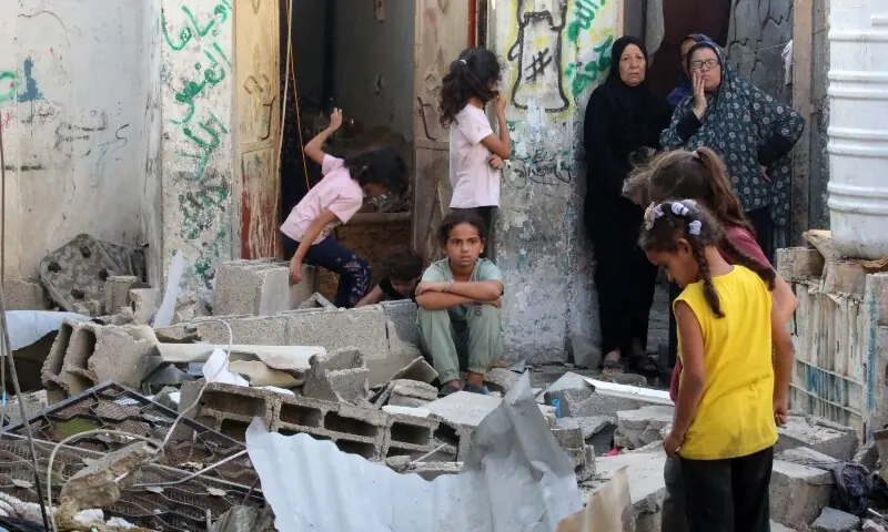 Palestinians check the damage outside a house hit by Israeli bombing in the Nuseirat refugee camp in the central Gaza Strip on September 27. &mdash; AFP