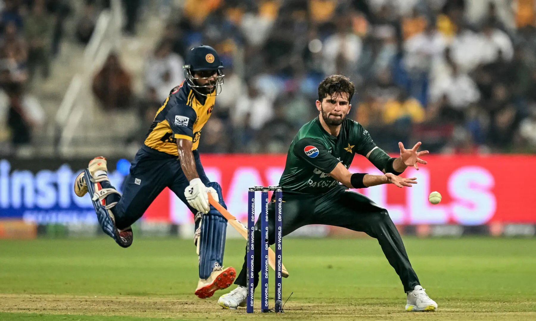 Sri Lanka’s Chamika Karunaratne (L) successfully runs to make his crease as Shaheen Shah Afridi attempts to run him out during the Asia Cup 2025 Super Four Twenty20 international cricket match between Pakistan and Sri Lanka at the Sheikh Zayed Cricket Stadium in Abu Dhabi on September 23, 2025. — AFP