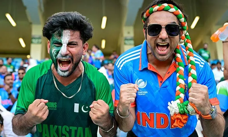 A Pakistani and an Indian fan pose for a photo before the start of the Asia Cup 2025 final between India and Pakistan at the Dubai International Stadium in Dubai, the UAE on September 28. &mdash; AFP