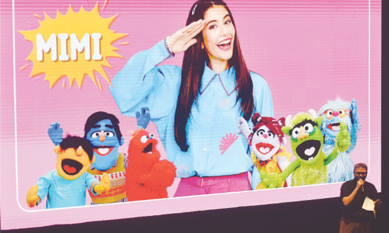 Bilal Maqsood speaks to the audience as his puppet creations are projected on a screen behind him.—Fahim Siddiqi / White Star