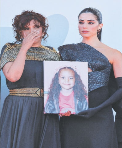 KAOUTHER Ben Hania and Saja Kilani hold a picture of Hind Rajab during the screening of The Voice of Hind Rajab in competition at the Venice Film Festival.&mdash;Reuters