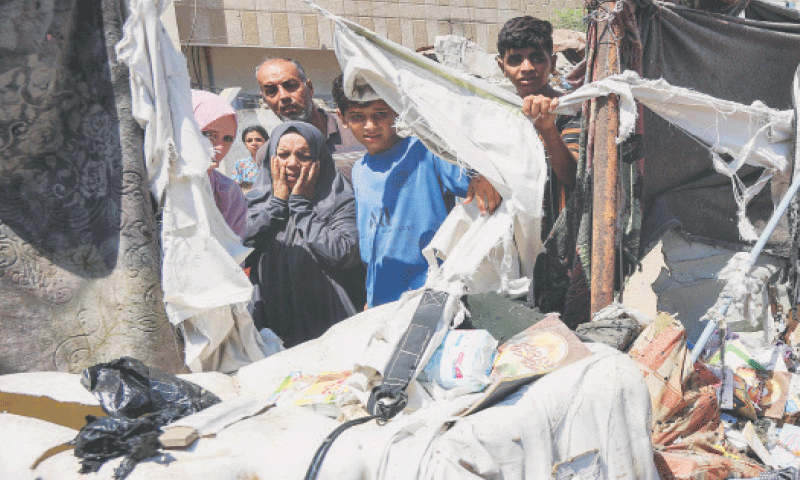 People inspect damage at a tent encampment after it was hit by Israeli bombardment near Shifa Hospital.—AFP People inspect damage at a tent encampment after it was hit by Israeli bombardment near Shifa Hospital.—AFP