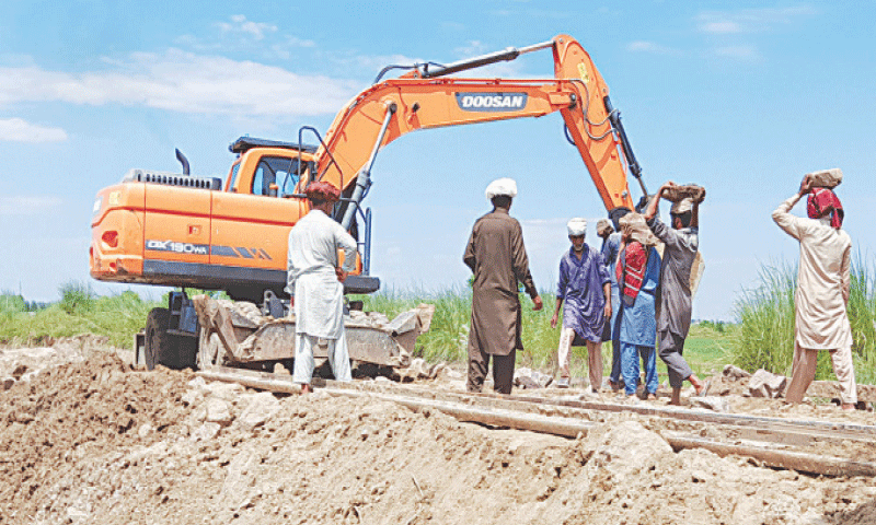 NAROWAL: Repair work in progress to restore the railway track on the Narowal-Sialkot section that was washed away by floods. — Dawn NAROWAL: Repair work in progress to restore the railway track on the Narowal-Sialkot section that was washed away by floods. — Dawn