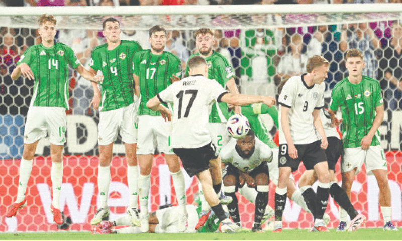 COLOGNE: Germany&rsquo;s Florian Wirtz (C) scores with a free-kick during the 2026 World Cup qualifier against Northern Ireland at RheinEnergieStadion.&mdash;AFP