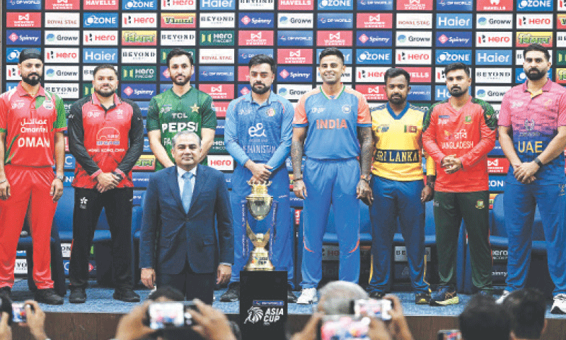 (L-R) captains of participating teams Oman&rsquo;s Jatinder Singh, Hong Kong&rsquo;s Yasim Murtaza, Pakistan&rsquo;s Salman Ali Agha, Afghanistan&rsquo;s Rashid Khan, India&rsquo;s Suryakumar Yadav, Sri Lanka&rsquo;s Charith Asalanka, Bangladesh&rsquo;s Litton Das and the UAE&rsquo;s Mohammad Waseem pose with the Asia Cup trophy alongside ACC president Mohsin Naqvi at the Dubai International Stadium on Tuesday.&mdash;AFP