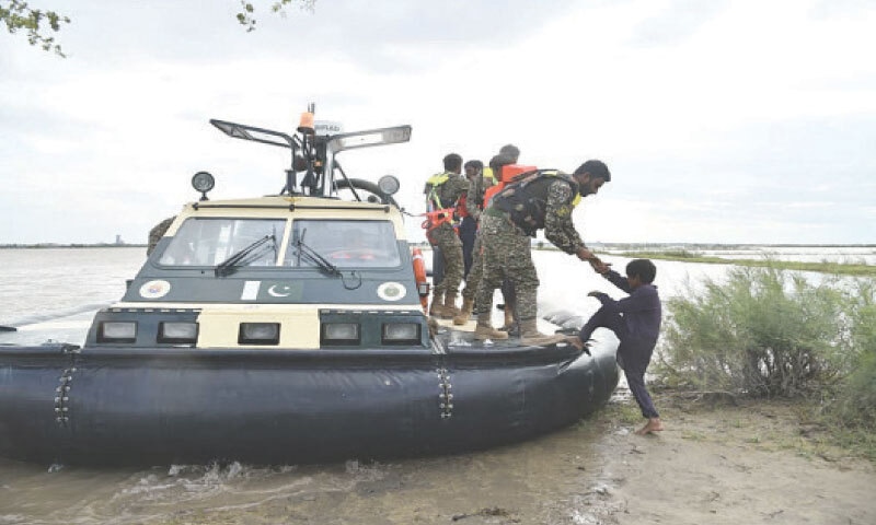 Pakistan Navy personnel, on board a hovercraft, rescue a young flood survivor in Sindh.—Online Pakistan Navy personnel, on board a hovercraft, rescue a young flood survivor in Sindh.—Online